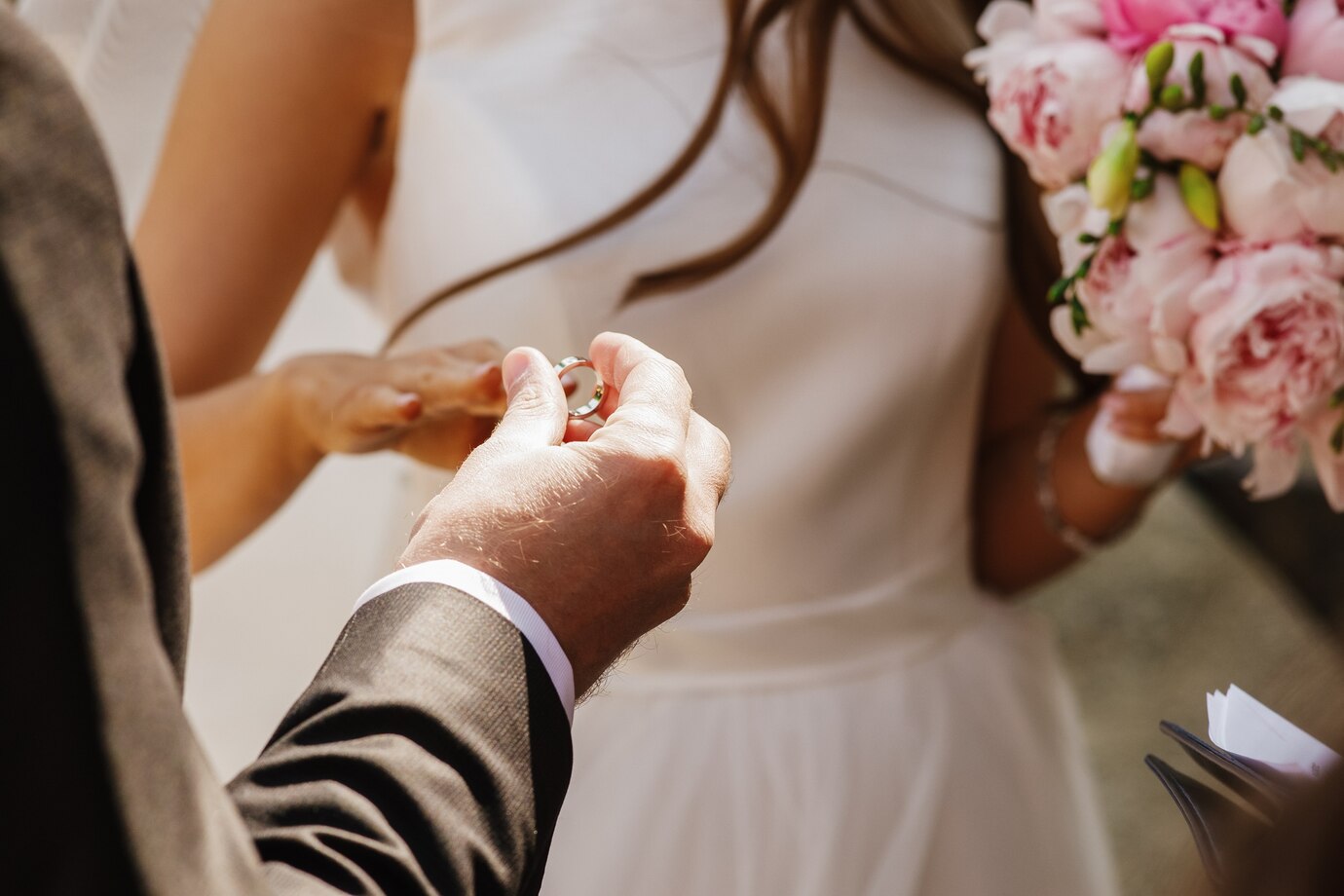 Groom puts wedding ring